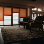 A warm, inviting living room showcasing classic furniture and a panoramic lake view.