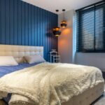 Stylish contemporary bedroom featuring a plush bed and chic lighting for a cozy ambience.